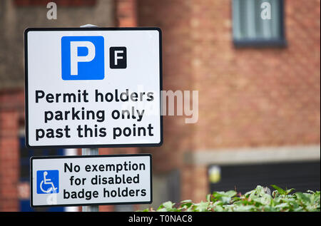 Notices showing parking places for permit holders only with no exemption for disabled badge holders Stock Photo
