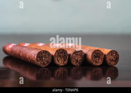A close up of five cuban cigars on table Stock Photo