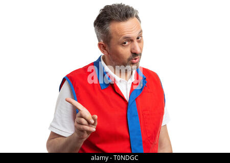 Closeup of male supermarket or hypermarket employee making forbidden gesture with index finger isolated on white studio background Stock Photo