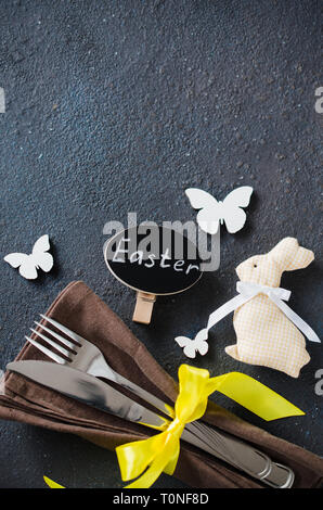 Festive table setting for holiday Easter dinner on dark table. Holidays background with copy space. Stock Photo