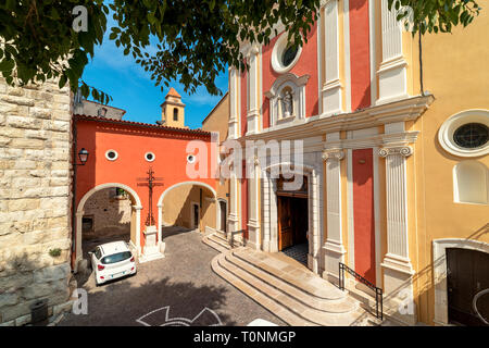 View of Antibes Cathedral on small town square and arched passage in Antibes, France. Stock Photo