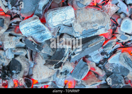 The dying embers in the fire close-up as background Stock Photo