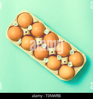 Easter eggs lie in a vintage tray on a blue background Stock Photo