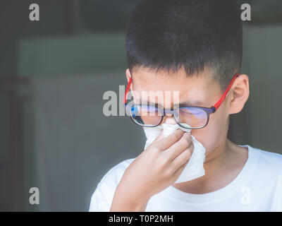 Boy get cold and blow runny nose with tissue. health concept.