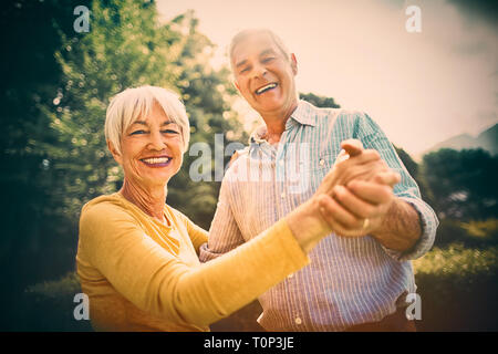 Senior couple dancing in park Stock Photo
