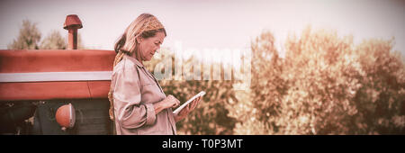 Woman using digital tablet in farm Stock Photo