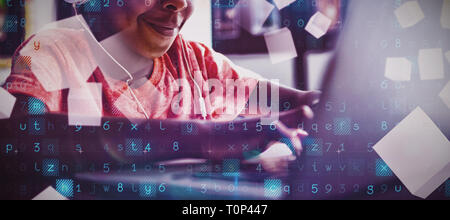 Boy listening music while using laptop Stock Photo