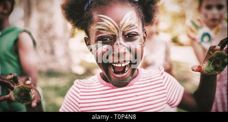 Portrait of a girl with make-up showing her painted hands Stock Photo