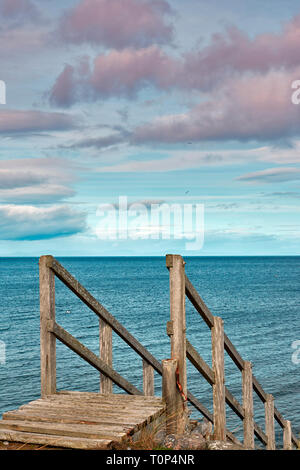 FINDHORN BEACH MORAY FIRTH SCOTLAND WOODEN STEPS FROM THE SAND DUNES INTO THE SEA Stock Photo