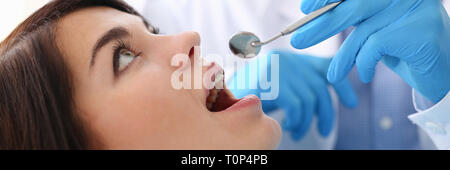 woman at the reception of a male dentist examining teeth Stock Photo