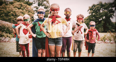Children wearing superhero costume standing Stock Photo