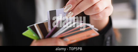 Female arm hold bunch of credit cards Stock Photo