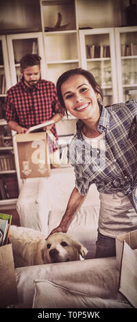 Happy couple unpacking cartons together Stock Photo