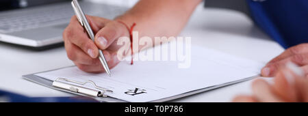 Male doctor hand write prescription at office worktable Stock Photo