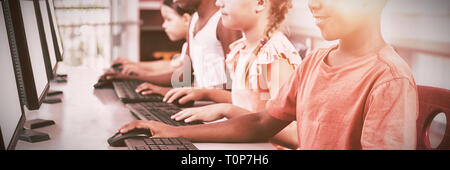 School kids using computer in classroom Stock Photo