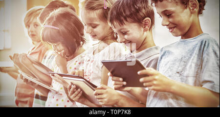 Smiling children using digital tablets Stock Photo