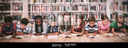Teacher reading books to her students Stock Photo