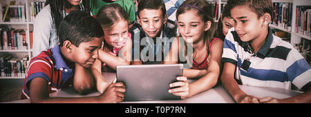 Front view of pupils using tablet pc Stock Photo