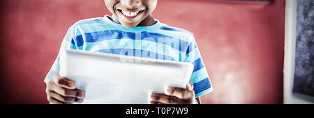 Schoolboy using digital tablet in classroom Stock Photo