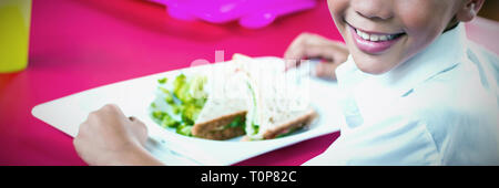 Children having lunch during break in cafeteria Stock Photo