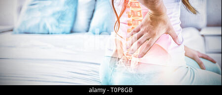 Digital composite of highlighted spine of woman with back pain Stock Photo