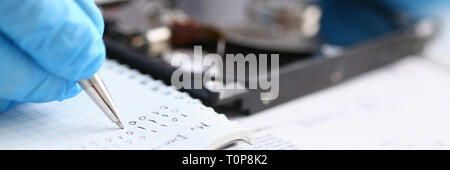 male repairman wearing blue gloves holding stethoscope on hard Stock Photo
