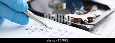 male repairman wearing blue gloves holding stethoscope on hard Stock Photo