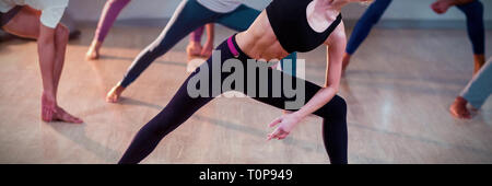 Portrait of people performing stretching exercise Stock Photo