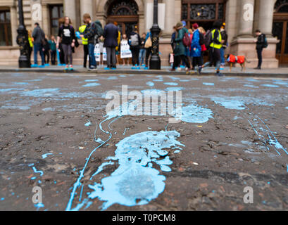 Glasgow, Scotland, UK. 21 March, 2019. A  'Blue Wave' demonstration by the Extinction Rebellion climate change protest group saw protesters make blue footprints, made from water-soluble paint, across George Square to the City Chambers. The peaceful protest briefly held up traffic. The Group aims to highlight threat of rising water levels in the River Clyde and of global climate change. Street covered in blue footprints. Credit: Iain Masterton/Alamy Live News Stock Photo