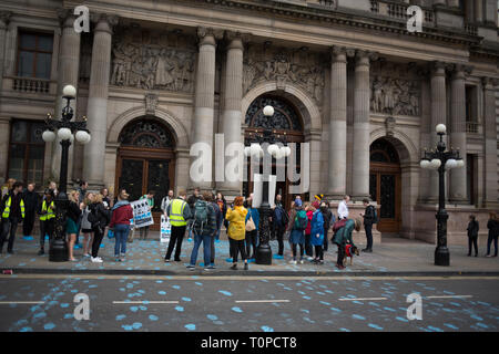 Glasgow, UK. 21st Mar, 2019. A 'Blue Wave' demonstration, painting blue foot prints across George Square and blocking the road, by Extinction Rebellion Scotland climate protestors, demanding that the City Council declare a climate emergency, and to raise awareness that sea levels and the city's River Clyde water levels are rising. In Glasgow, Scotland, 21 March 2019. Photo byline Credit: jeremy sutton-hibbert/Alamy Live News Stock Photo