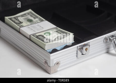 Open suitcase with one million dollars bills with tape on white background Stock Photo