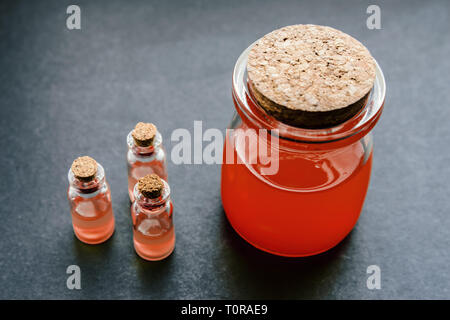 Red liquid in a glass jar. Selective focus and shallow depth of field. Stock Photo