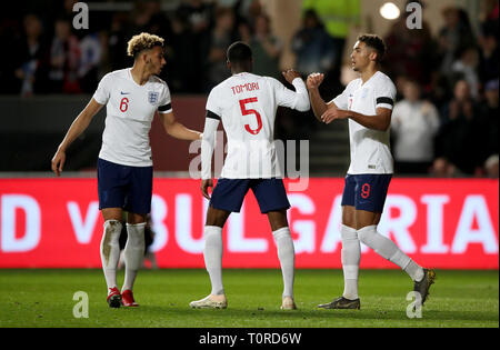 England's Dominic Calvert-Lewin (right) celebrates scoring his side's first goal of the game with team-mates Fikayo Tomori (centre) and Lloyd Kelly (left) during the International Friendly match at Ashton Gate, Bristol. Stock Photo