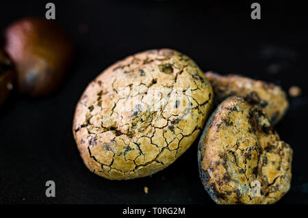 Untreated cocoa beans on black background, close-up, macro Stock Photo