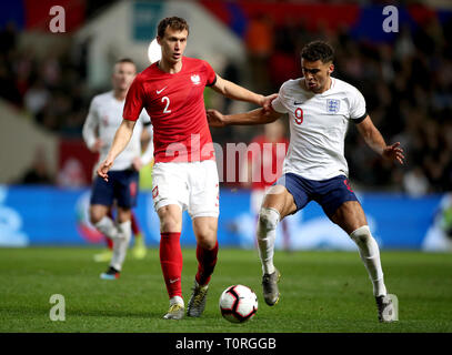 England's Dominic Calvert-Lewin (right) and Poland's Krystian Bielik (left) battle for the ball during the International Friendly match at Ashton Gate, Bristol. Stock Photo