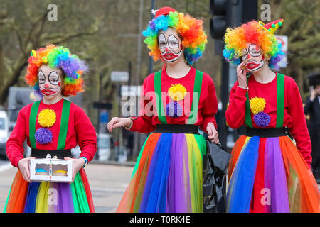 Orthodox Jewish women are seen dressed as clowns during the festival of Purim on the streets of Stamford Hill in north London. Purim is one of the most entertaining Jewish holidays. It commemorates the time when the Jewish people living in Persia were saved from massacre by Haman. It is customary to hold the carnival-like celebrations on Purim, and for groups of men to go round visiting local wealthy men, collecting for their charity. Stock Photo