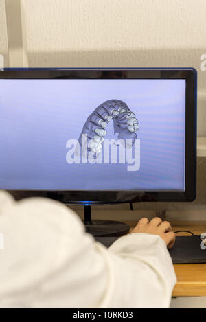 Woman working on computer with dental software platform Stock Photo