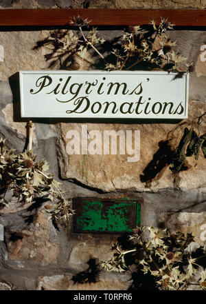 Donations box inside St Beuno's church, Pistyll, North Wales, UK; a stopping place on the pilgrim route down E coast of the Lleyn Peninsula to Bardsey Stock Photo