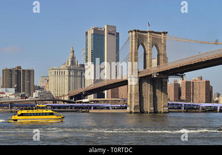 New York City, USA - February 3, 2019: New York Water Taxi ferry boat on the East River near the Brooklyn Bridge, Lower Manhattan. Stock Photo