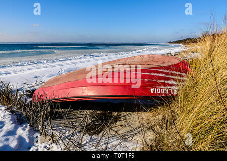 Hel Peninsula, Poland, January 23, 2019: Red fishing boat on beach in Jastarnia Stock Photo