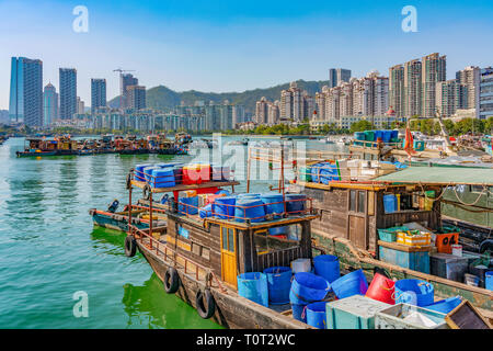 SHENZHEN, CHINA - OCTOBER 30: Traditional Chinese fishing boats at the Shekou fishing port with high rise city buildings in the distance on October 30 Stock Photo