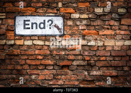 Uncertainty Concept Image Of A Grungy Sign Saying End? On An Old Red Brick Wall Stock Photo