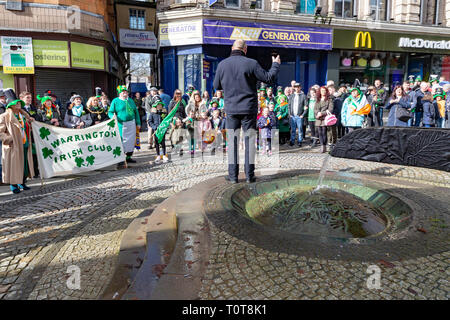 The annual St Patrick’s Day Parade from The Irish Club in Orford Lane to ‘The River of Life’ in Bridge Street. A short service remembered the 25th ann Stock Photo