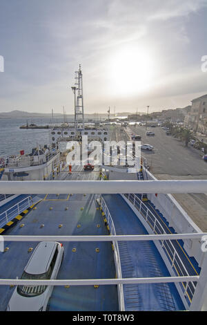 ISOLA MADDALENA, SARDINIA, ITALY - MARCH 7, 2019: Ferry car deck and port area city view with sea promenade near sunset on March 7, 2019 in La Maddale Stock Photo
