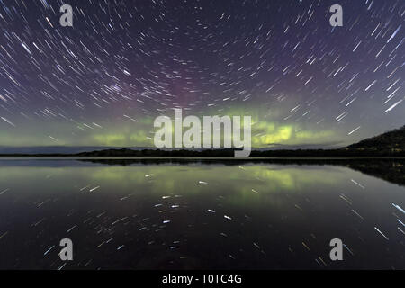 Star Trail and Aurora Australis or Southern Lights reflected in still water Stock Photo