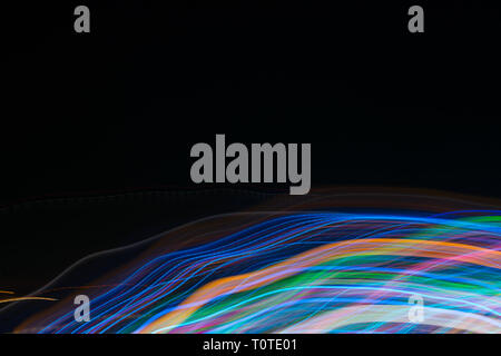 Abstract blurred light lines on black background. Light trails against dark background. Stock Photo