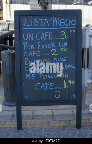 PALMA DE MALLORCA, SPAIN - MARCH 17, 2019: Blackboard with prices for coffee in Spanish, an incentive how to save money by being more polite on March  Stock Photo