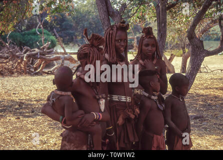 Group of young women and children of the Himba ethnic group near the Epupa Falls on the Kunene River in Namibia, border with Angola Stock Photo