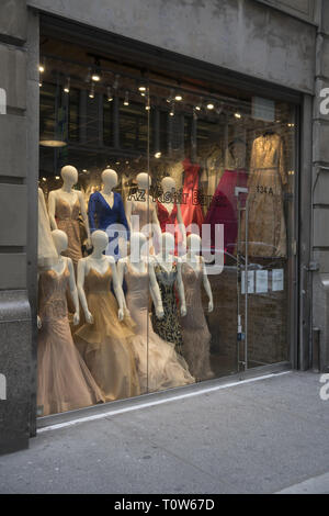 Women's evening dresses on display in a store window. Garment District on the Westside of midtown Manhattan. Stock Photo