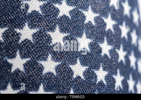 An extreme close-up or a macro shot of a small fabric printed with the motif and design of an American or United States flag. Stock Photo